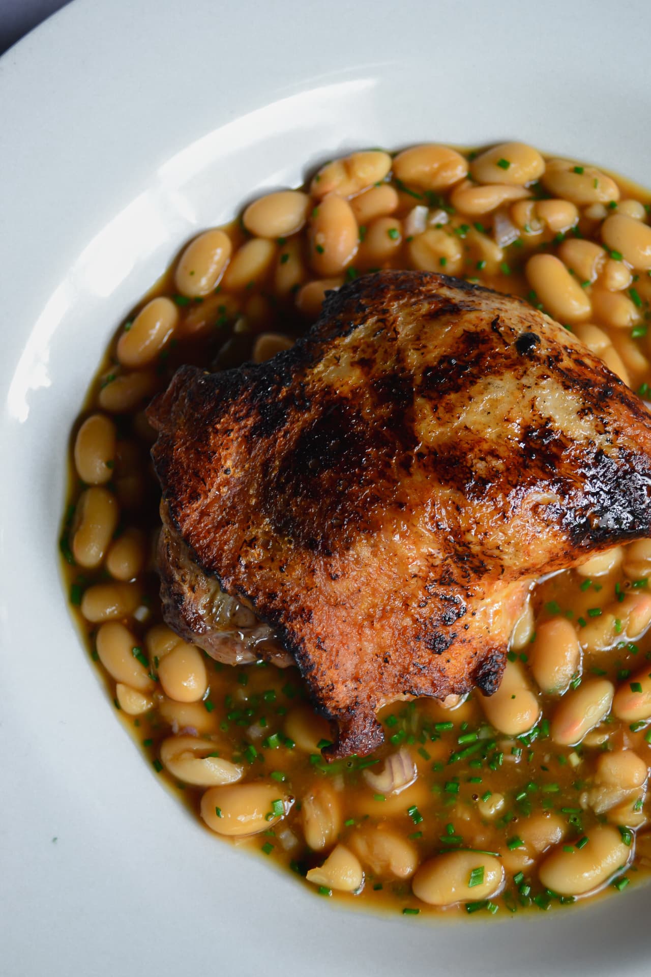 Crisp duck leg with white beans and chives